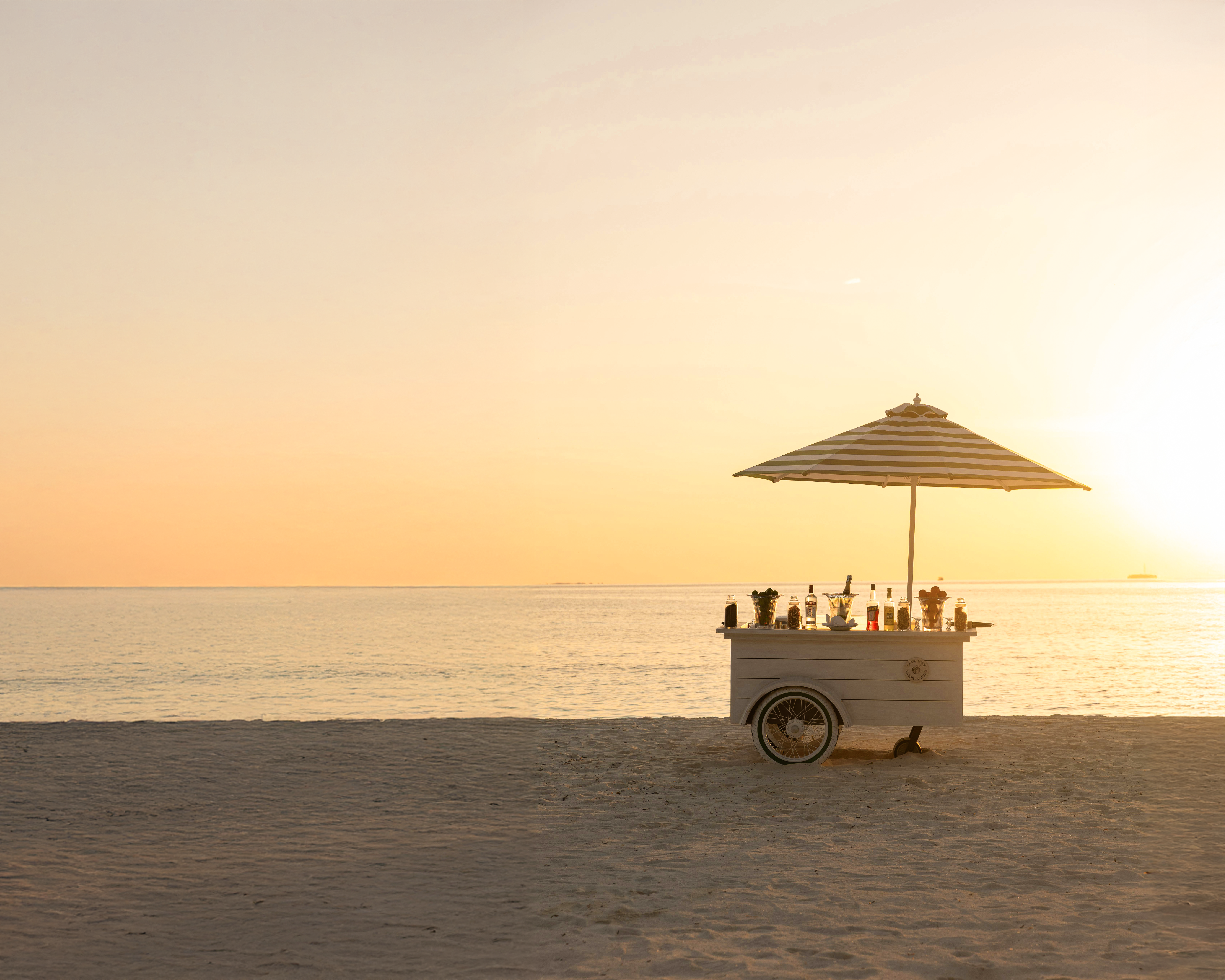 Beachside drinks cart at sunset, representing alcohol availability and drinking rules in Dubai