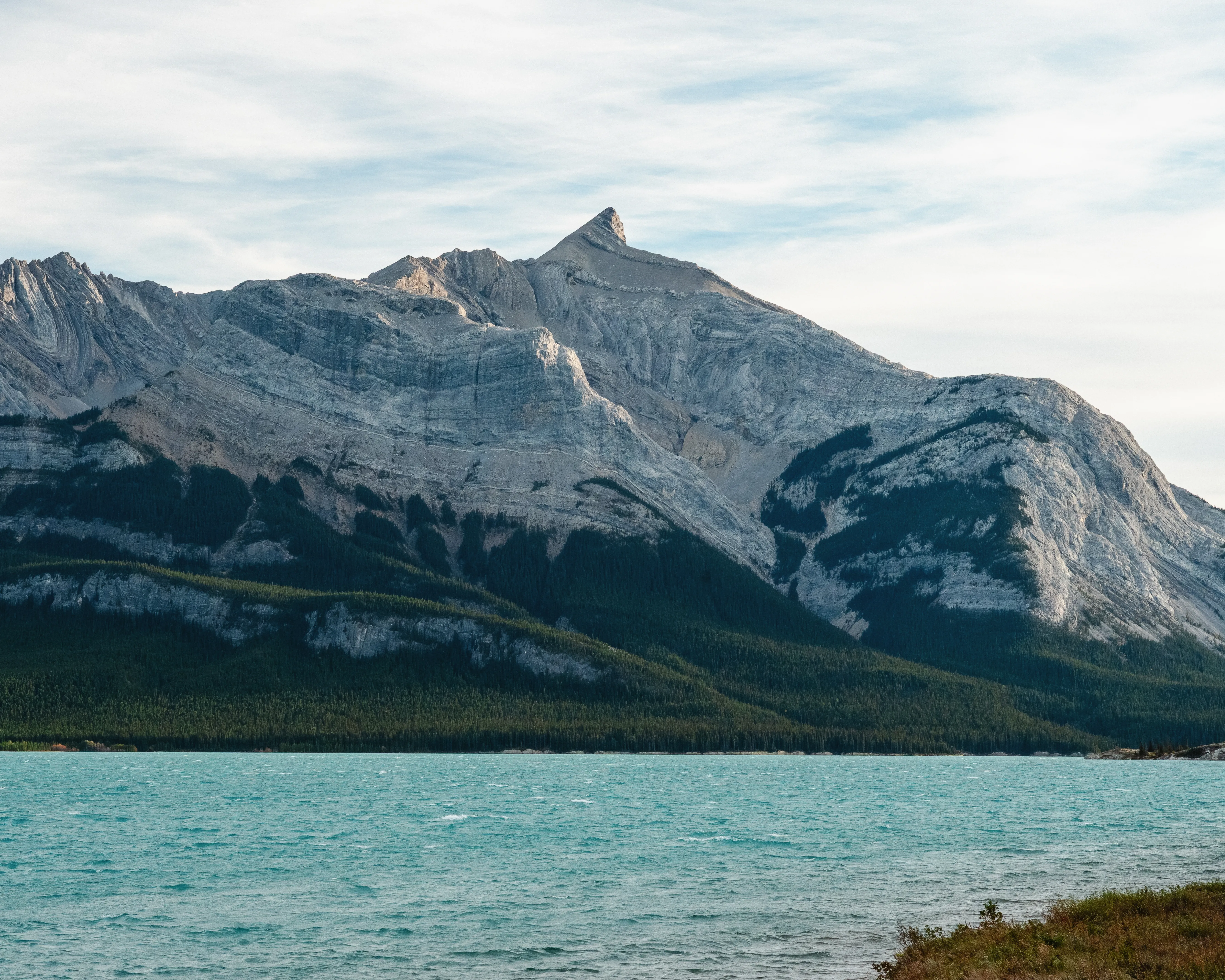 Mountain landscape and turquoise lake in Banff National Park, Canada, during September when autumn colours begin to appear.