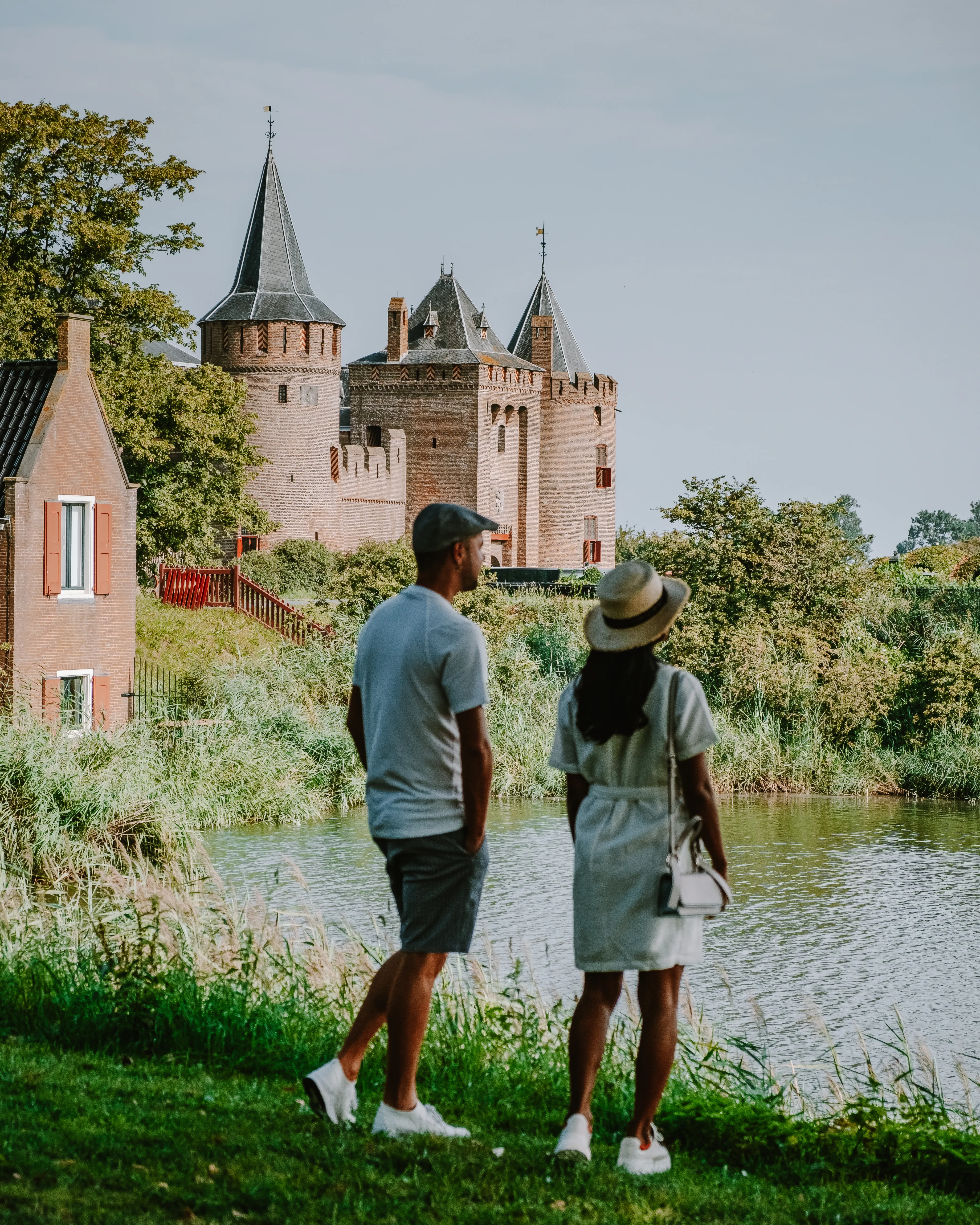 Visitors admiring Muiderslot Castle, one of the Netherlands' best-preserved medieval castles.