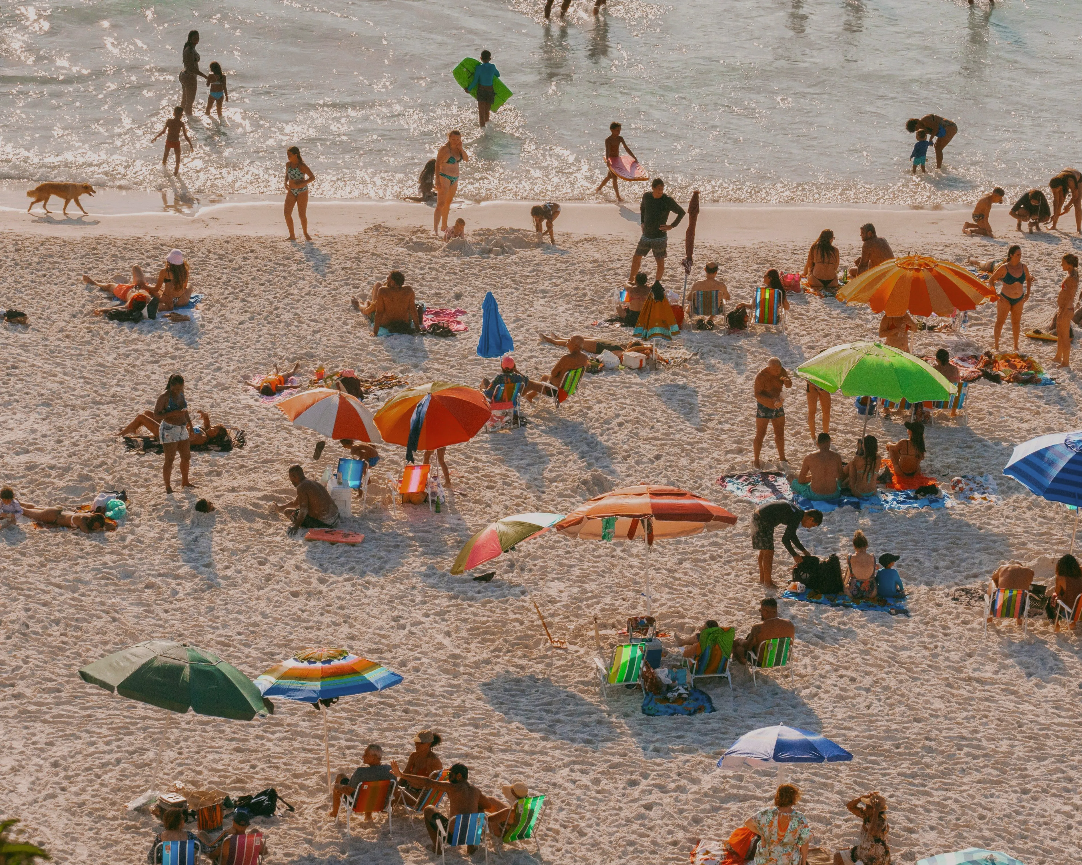 Visitors relaxing and swimming on a sandy beach in New Caledonia